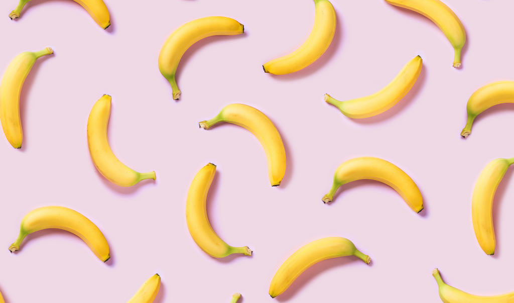 Bananas in purple background. Are bananas good for dogs?